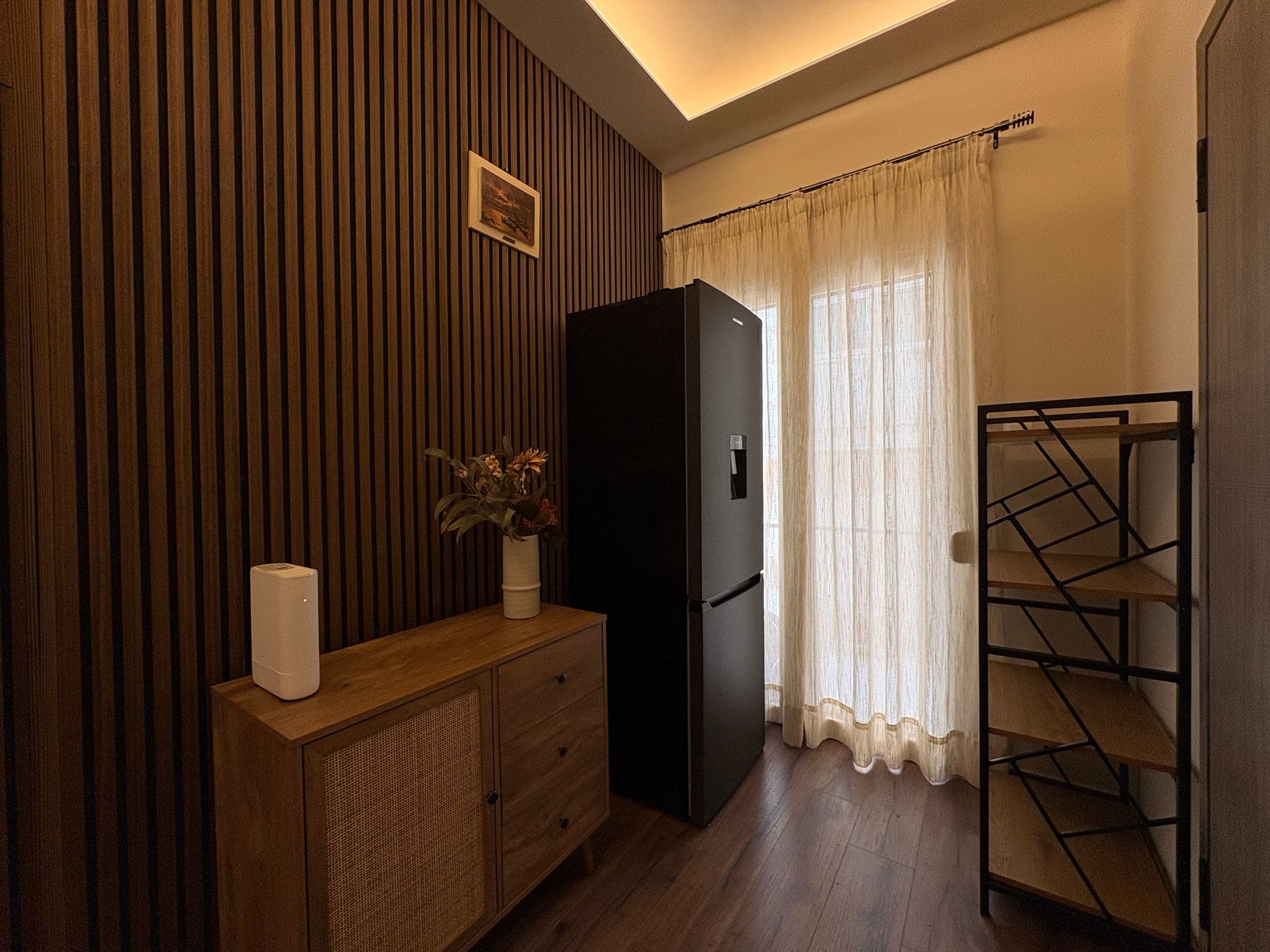 Slatted timber feature wall with sideboard and fridge after renovation